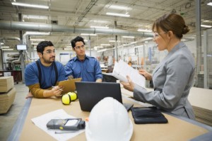 Manager discussing with workers in factory