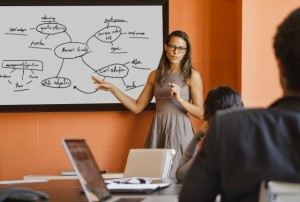 Businesswoman showing diagram to colleagues