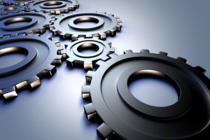 Illustration of cogwheels representing industry and engineering, studio shot on grey background
